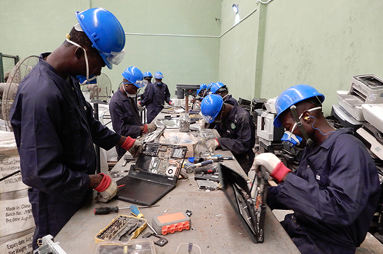 Worker disassembling e-waste